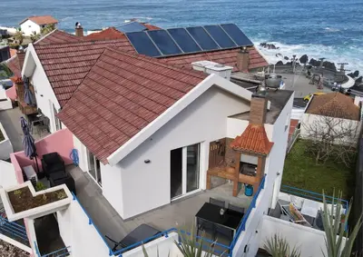 an aerial view of a house with solar panels on the roof at Sea and Sun 4 You - Horizonte Azul in Porto Moniz