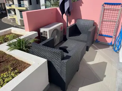 a patio with two chairs and a heater at Sea and Sun 4 You - Horizonte Azul in Porto Moniz