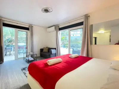 a bedroom with a large bed with a red blanket at Sea and Sun 4 You - Horizonte Azul in Porto Moniz