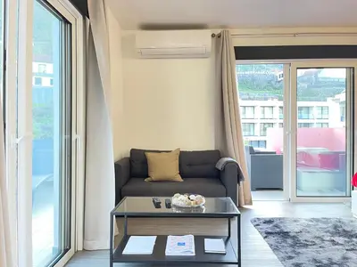 a living room with a couch and a table at Sea and Sun 4 You - Horizonte Azul in Porto Moniz