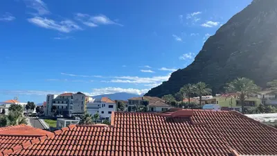 a view of a town with red roofs and a mountain at Sea and Sun 4 You - Horizonte Azul in Porto Moniz
