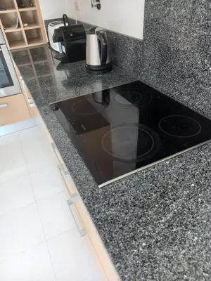 a kitchen counter with a stove top in a kitchen at La Suite Calypso in Luz