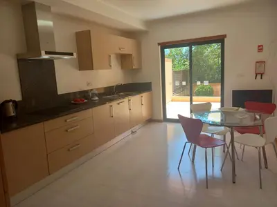 a kitchen with a table and chairs and a dining room at La Suite Calypso in Luz