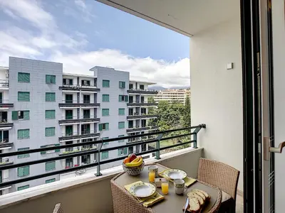 a balcony with a table with a bowl of fruit on it at Paradise Apartment by LovelyStay in Funchal
