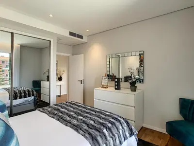 a bedroom with a bed and a mirror at Paradise Apartment by LovelyStay in Funchal