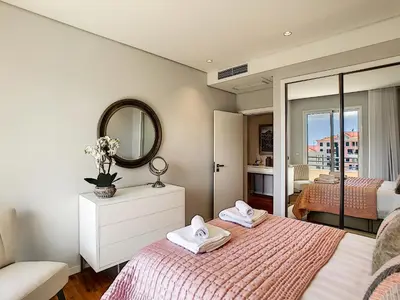 a bedroom with a bed and a mirror at Paradise Apartment by LovelyStay in Funchal