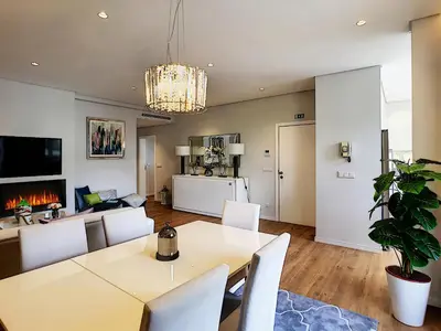a dining room and living room with a table and chairs at Paradise Apartment by LovelyStay in Funchal