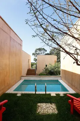 a swimming pool in the yard of a house at Praia do Canal Nature Retreat - Small Luxury Hotels of the World in Aljezur
