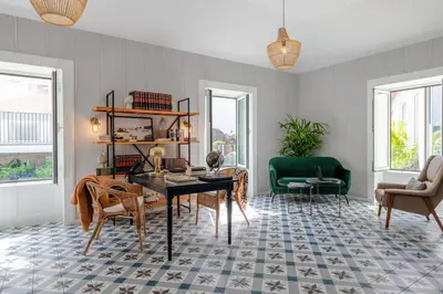 a living room with a table and chairs at Pestana Fisherman Village in Câmara de Lobos