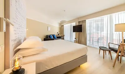 a hotel room with a bed and a large window at Pestana Fisherman Village in Câmara de Lobos