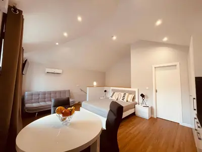 a bedroom with a bed and a table and a couch at Living Funchal Apartments in Funchal