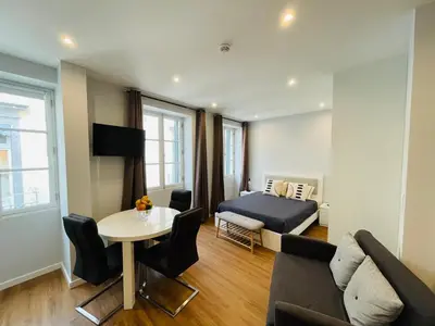 a bedroom with a bed and a table and a couch at Living Funchal Apartments in Funchal