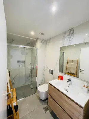 a bathroom with a sink and a toilet and a mirror at Living Funchal Apartments in Funchal