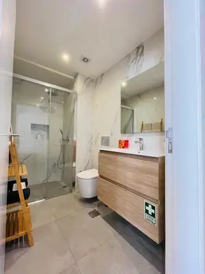a bathroom with a shower and a toilet and a sink at Living Funchal Apartments in Funchal