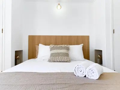 a bedroom with a bed with two towels on it at REFÚGIO DO CARANGUEJO - Praia da Luz - WiFi, Private Pool & BBQ in Luz