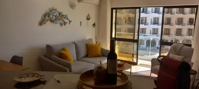 a living room with a couch and a table at Salema Beach Apartment in Salema
