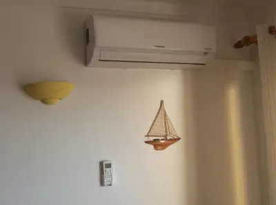 a toy boat hanging on a wall next to a ceiling at Salema Beach Apartment in Salema