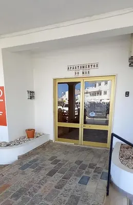 a entrance to a building with a glass door at Salema Beach Apartment in Salema