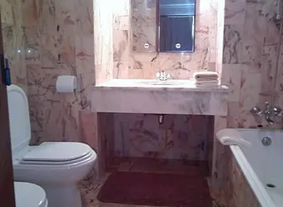 a bathroom with a sink and a toilet and a tub at Salema Beach Apartment in Salema