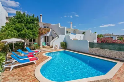 a villa with a swimming pool and patio furniture at Villa Cinco by Villa Plus in Luz