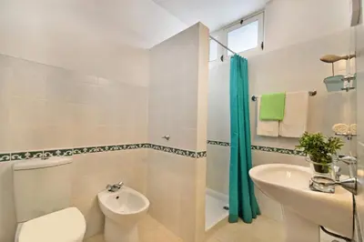 a bathroom with a sink and a toilet and a shower at Villa Cinco by Villa Plus in Luz