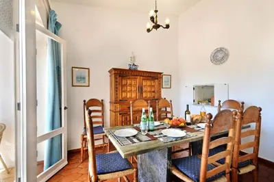 a kitchen and dining room with a table and chairs at Villa Cinco by Villa Plus in Luz