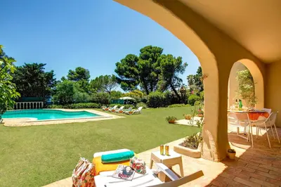 a backyard with a pool and a table and chairs at Villa Sounia by Villa Plus in Lagos