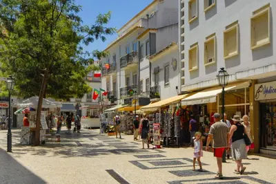 a group of people walking down a street with stores at Villa Sounia by Villa Plus in Lagos