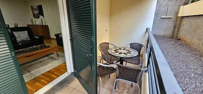 a balcony with a table and chairs and a couch at Suncoast Residence V (Free parking) in Funchal