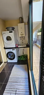 a small kitchen with a washing machine and a washer at Suncoast Residence V (Free parking) in Funchal