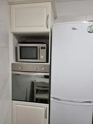 a kitchen with a microwave and a refrigerator at Suncoast Residence V (Free parking) in Funchal
