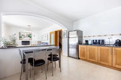 a kitchen with a table and chairs in a room at Sweet Home Sagres in Sagres
