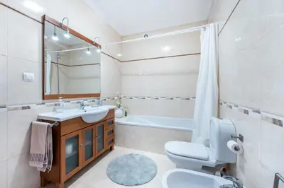 a bathroom with a toilet and a sink and a tub at Sweet Home Sagres in Sagres