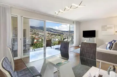 a living room with a view of a city at 1 Bed Apartment Sleeps 4 with Pool in Funchal