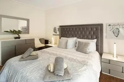 a bedroom with a large bed with towels on it at 1 Bed Apartment Sleeps 4 with Pool in Funchal