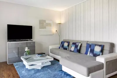 a living room with a couch and a tv at 1 Bed Apartment Sleeps 4 with Pool in Funchal