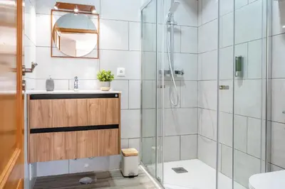 a bathroom with a shower and a toilet and a sink at Kichershome in Sagres