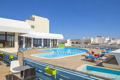a pool on the roof of a building at Magnólia Mar Senses in Lagos