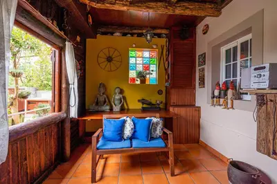 a room with a blue chair and a window at Chalet do Monte no Porto Moniz by Homie in Lanceiros