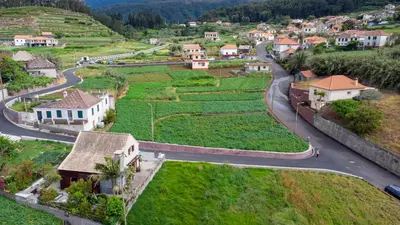 an aerial view of a small village with a winding road at Chalet do Monte no Porto Moniz by Homie in Lanceiros