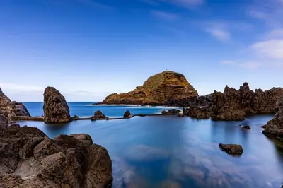 a rocky beach with rocks in the water at Chalet do Monte no Porto Moniz by Homie in Lanceiros