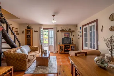 a living room with a couch and a table at Chalet do Monte no Porto Moniz by Homie in Lanceiros