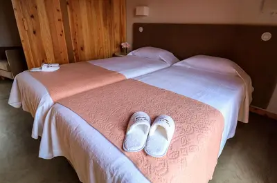 a pair of shoes sitting on top of a bed at QUINTA DO FALCÃO in Almagreira