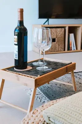 a bottle of wine and a wine glass on a table at Blue Villa H - Sagres - 10 min walk to the beach in Sagres