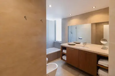 a bathroom with a sink and a tub and a mirror at Blue Villa H - Sagres - 10 min walk to the beach in Sagres