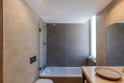 a bathroom with a shower and a toilet and a sink at Blue Villa H - Sagres - 10 min walk to the beach in Sagres