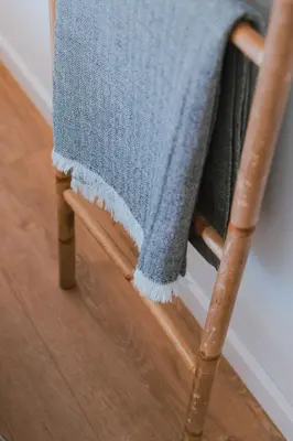 a blue towel sitting on a wooden chair at Blue Villa H - Sagres - 10 min walk to the beach in Sagres