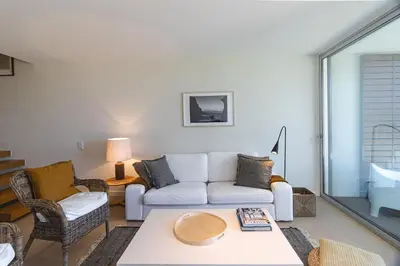a living room with a couch and a table at Blue Villa H - Sagres - 10 min walk to the beach in Sagres