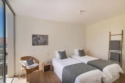 two beds in a room with white walls at Blue Villa H - Sagres - 10 min walk to the beach in Sagres