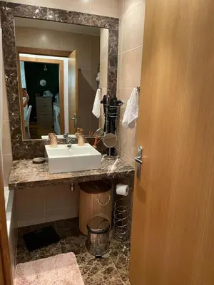 a bathroom with a sink and a mirror at Ajuda Paradise apartment with pool and private parking in Funchal